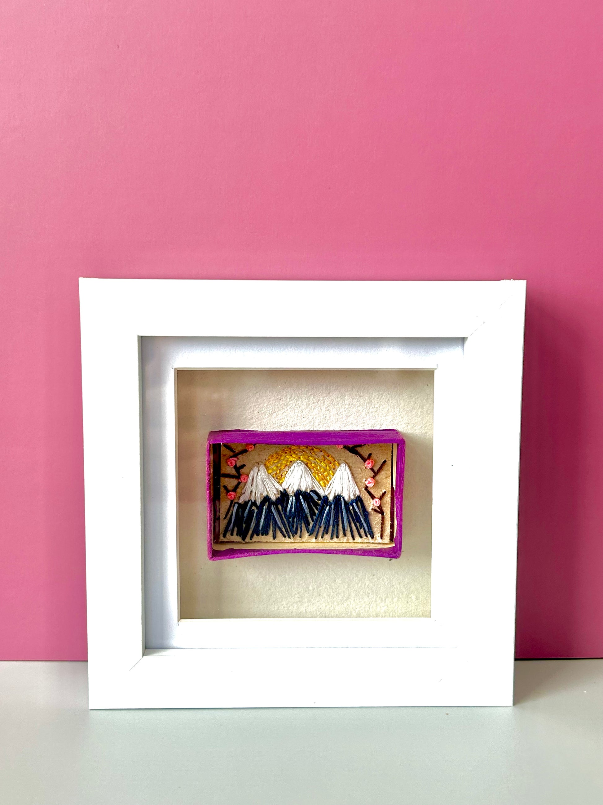 Vintage matchbox embroidered with a mountain scene reminiscent of Mount Fuji